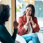 A customer smiles as they speak with an independent insurance agent. 